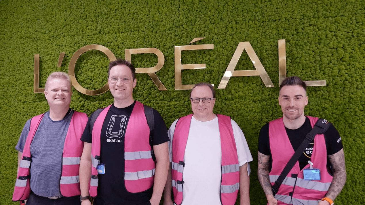 Warehouse Wi-Fi team standing in front of sign